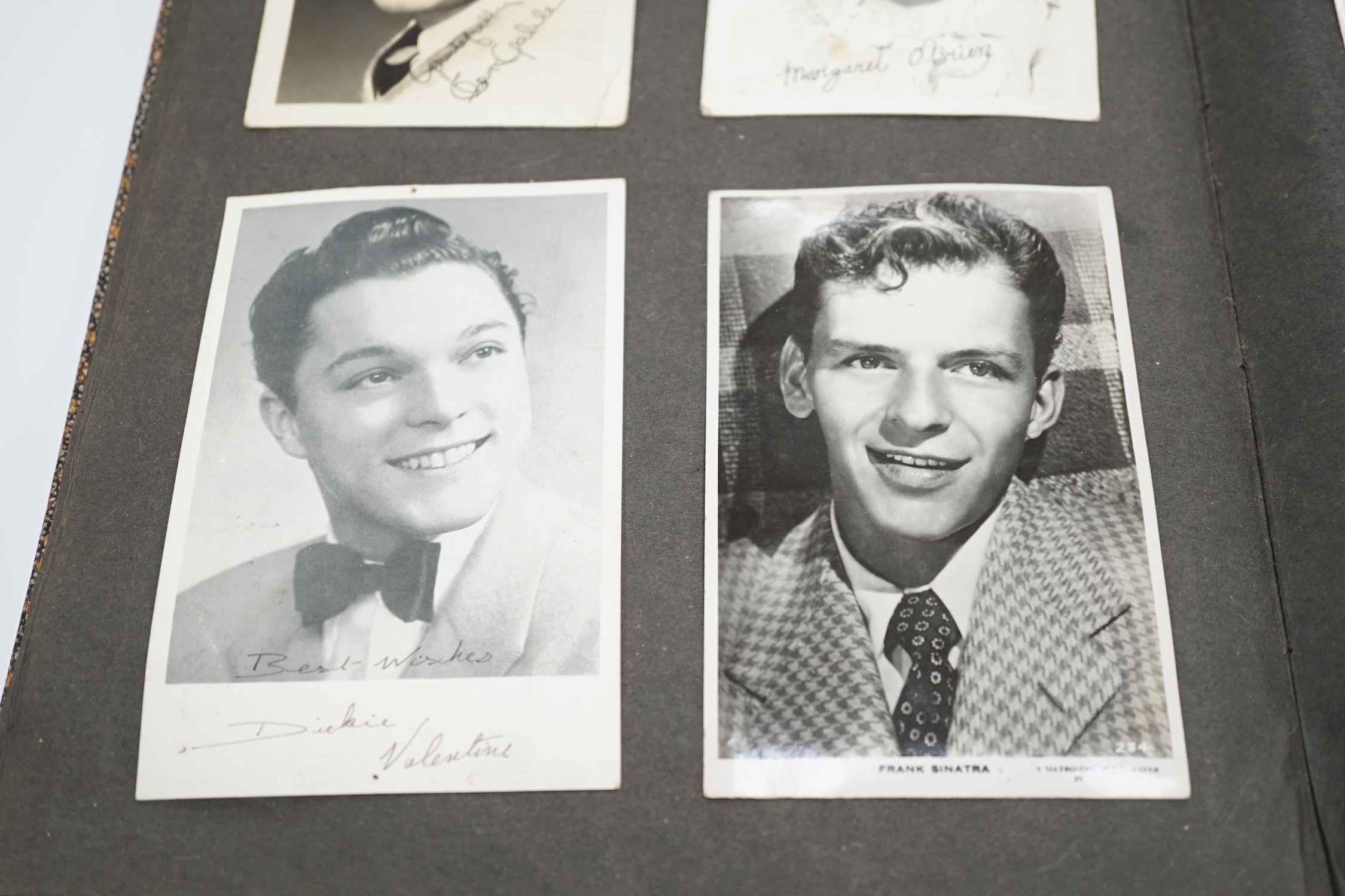 A vintage black and white photograph album with some autographs including Lucille Ball and Margaret O’Brien